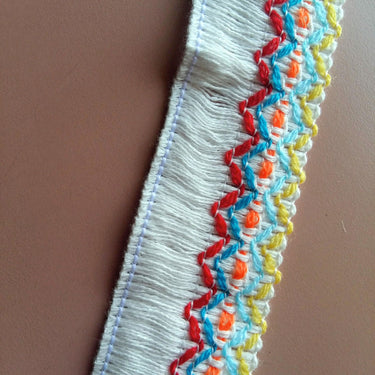 White / Black Threaded Trim With Red, Blue, Yellow And Orange Embroidery